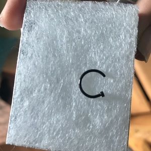 Black nose ring piercing